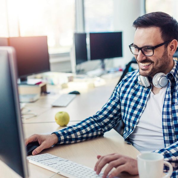Programmer working in the office and smiling
